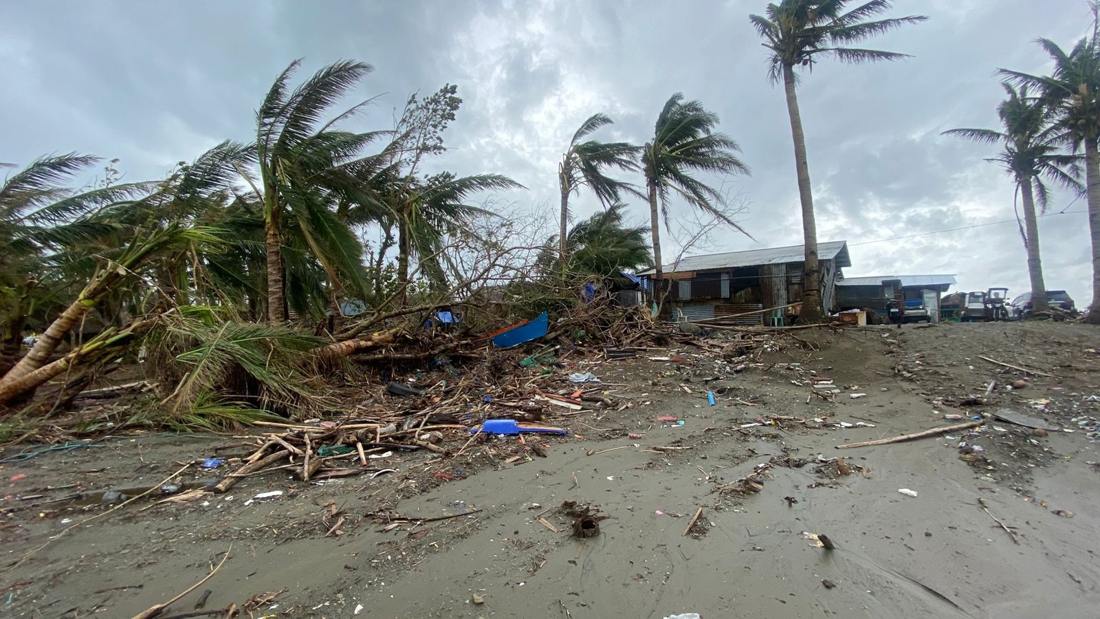 Volunteers crossing a river carrying aid boxes